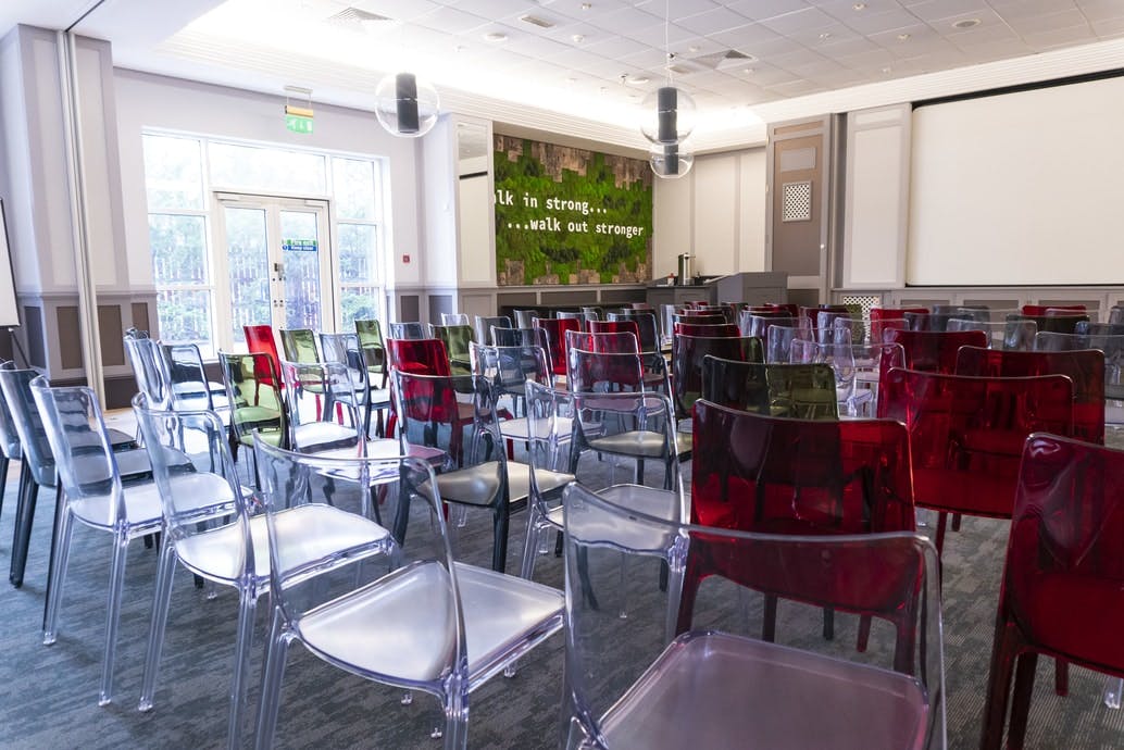 Modern meeting space with colorful chairs at Wilmslow Conference Centre.