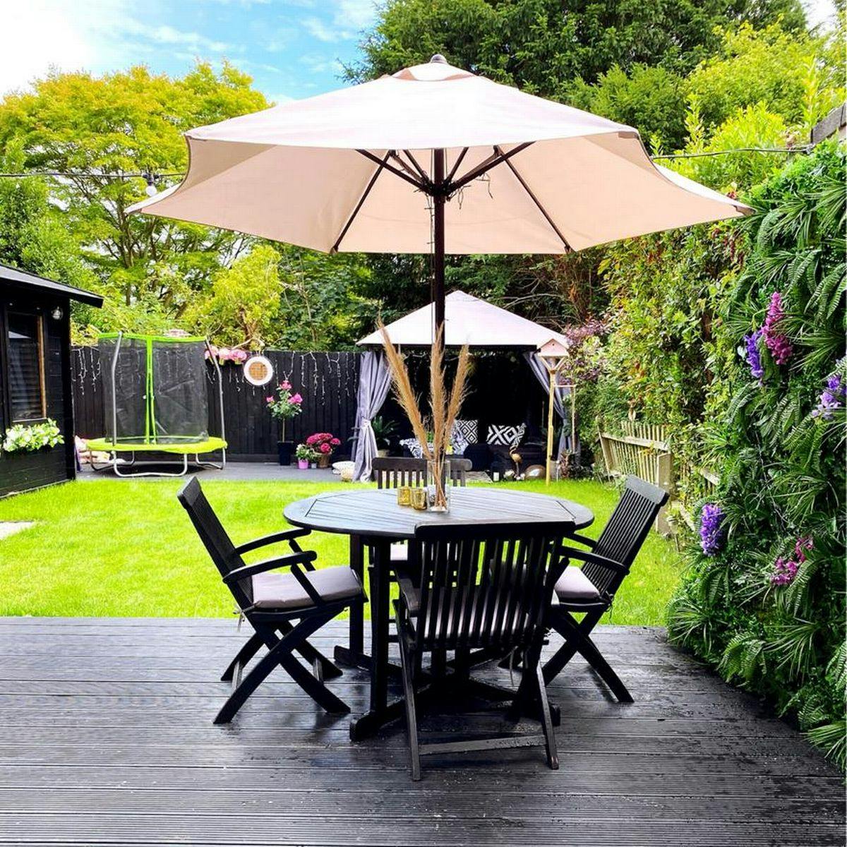 Charming outdoor deck with round table, ideal for team-building and networking events.
