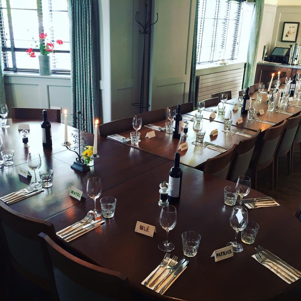 Private dining room setup with elegant tables for networking and celebratory events.