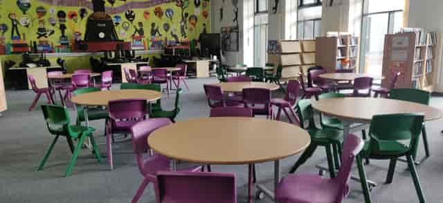 Main Hall at Harborne Academy with round tables, ideal for workshops and events.