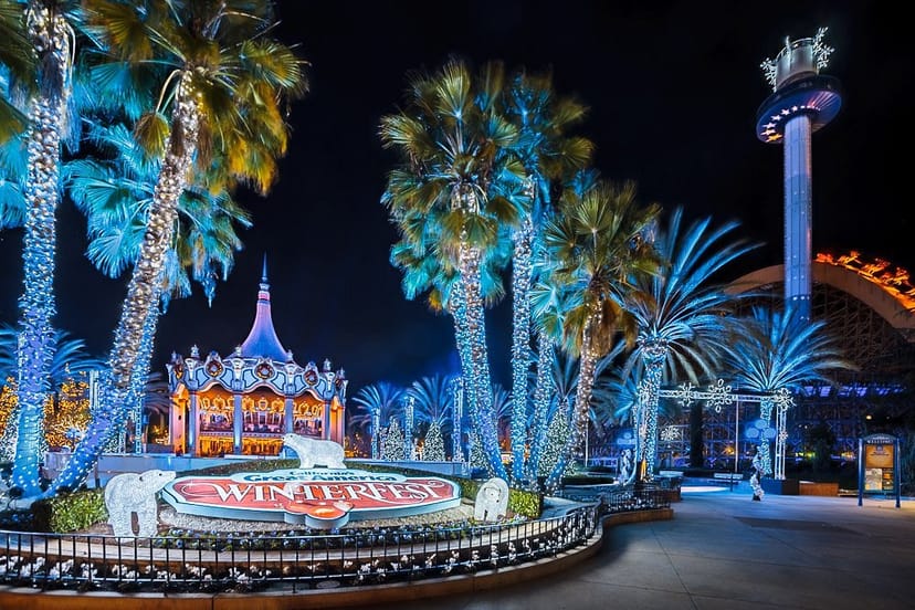 Theatre Royale at night, vibrant event space with festive decor and palm trees.