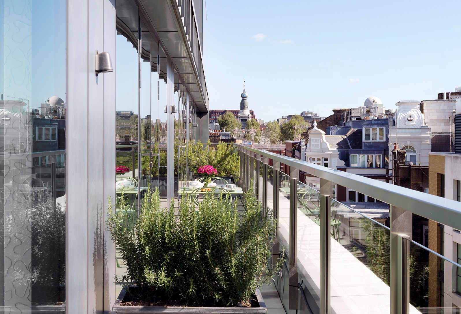 Rooftop terrace at Ham Yard Hotel with city skyline view, perfect for outdoor events. - Banner