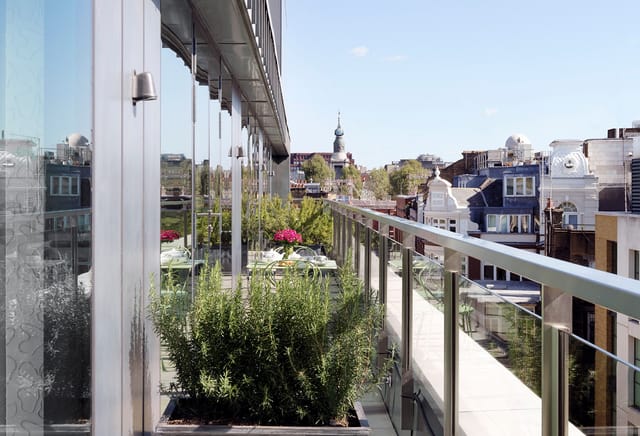 Rooftop terrace at Ham Yard Hotel with city skyline view, perfect for outdoor events.