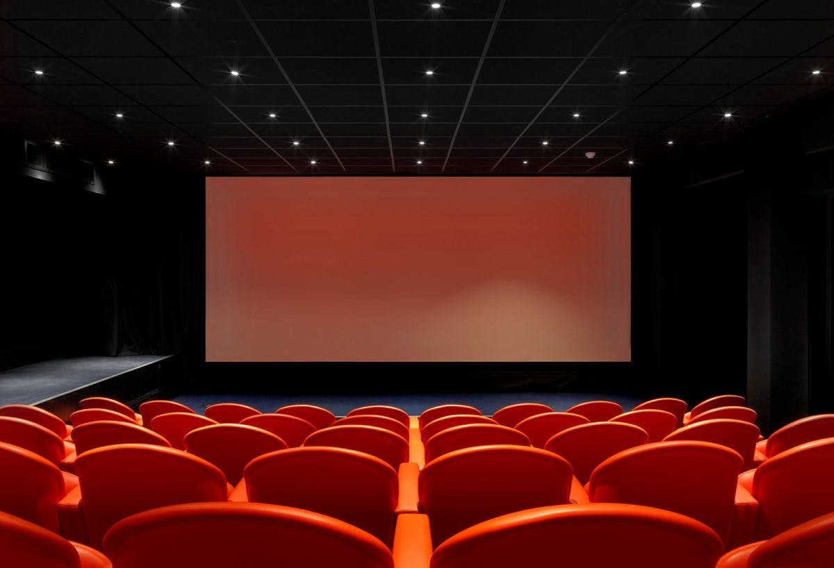 Modern screening room with red seating, perfect for presentations and film events.