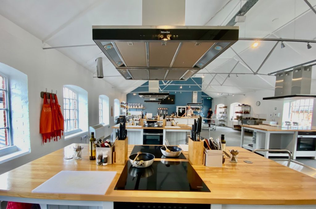 Modern kitchen venue for culinary events and workshops with professional appliances. - Banner