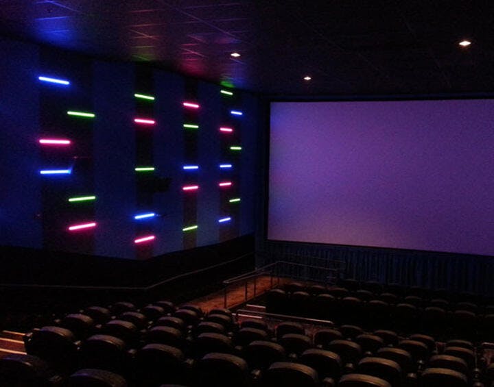 Modern cinema space with neon lighting, perfect for film screenings and presentations.