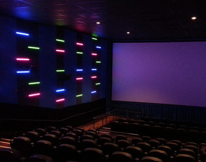 Modern cinema space with neon lighting, perfect for film screenings and presentations.