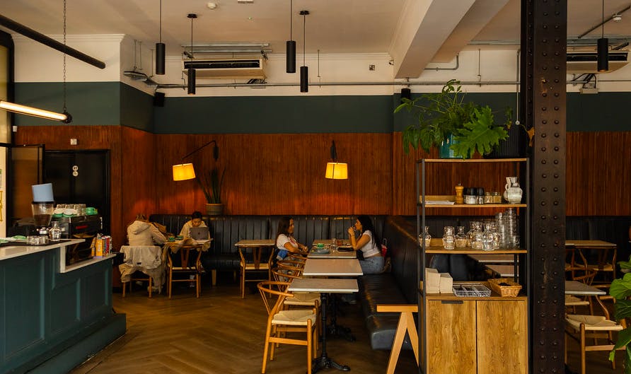 Stylish café with warm wood accents, ideal for networking events and meetings.