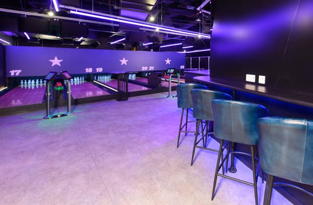 Duckpin Lounge at O2: vibrant bowling alley with neon lights for events and gatherings.