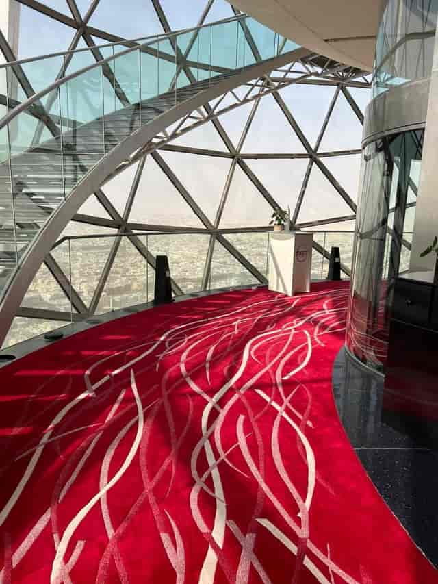 Modern event space with panoramic views and red carpet at The Globe, Riyadh.