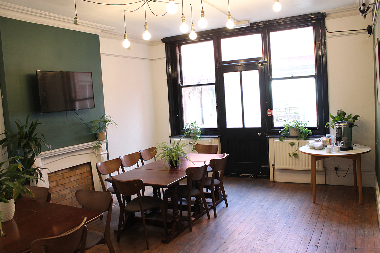 Versatile meeting space in Stanley Arts, London with natural light and greenery for workshops. - Banner