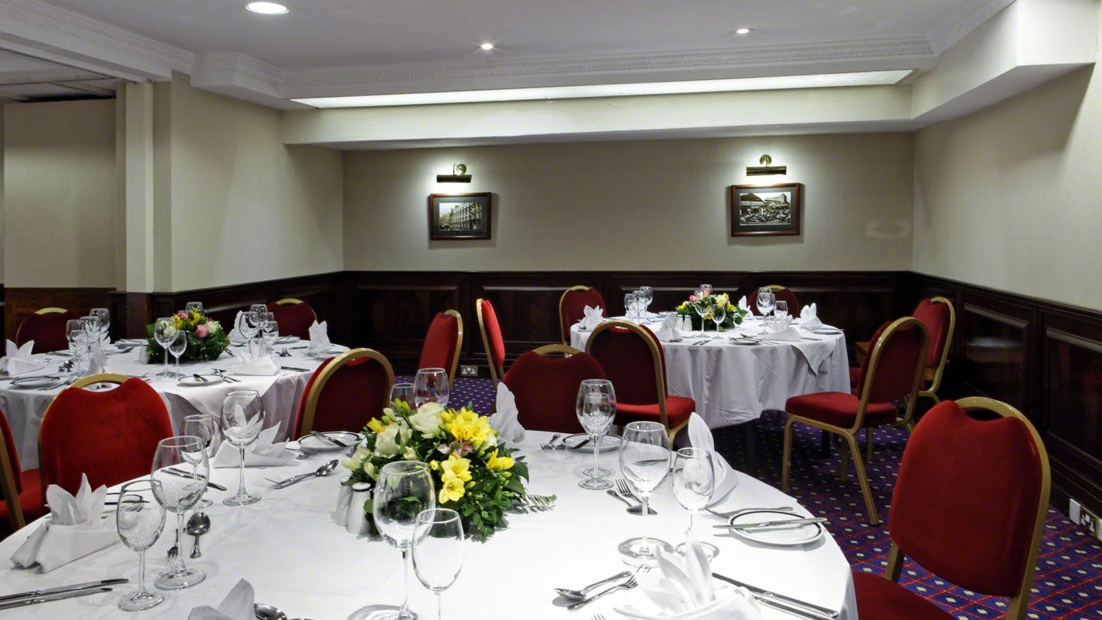Rochester Suite meeting space with elegant round tables for corporate events.