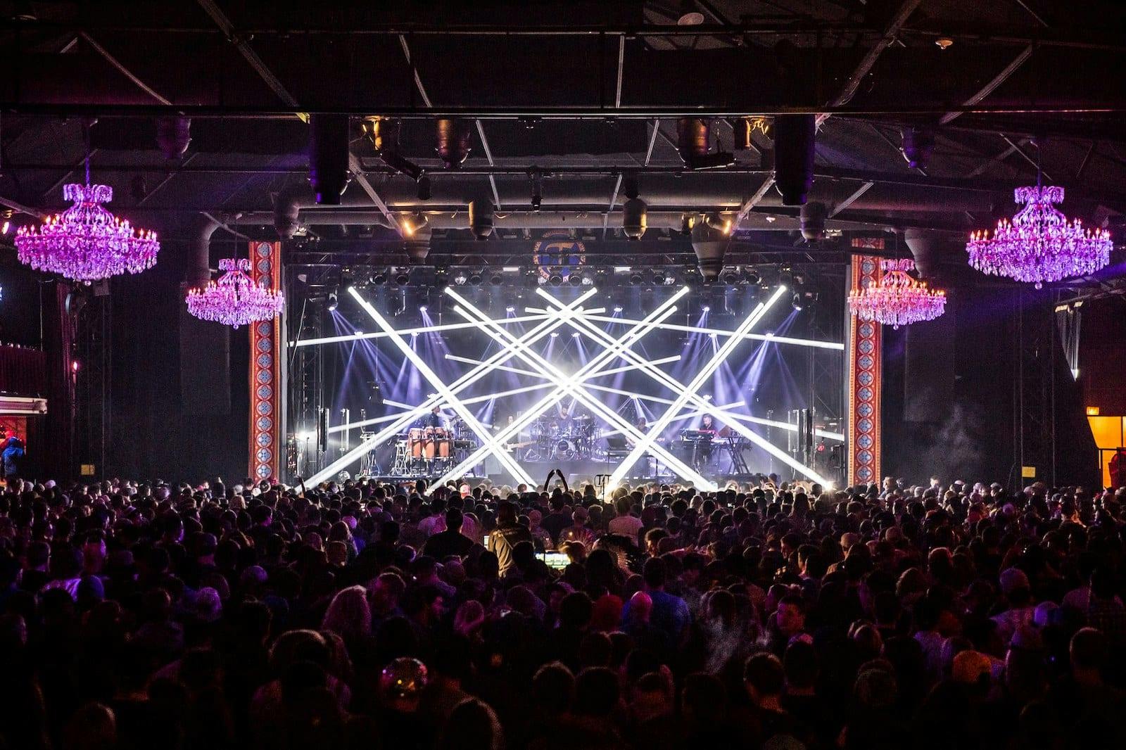 Vibrant Fillmore Auditorium balcony with chandeliers, perfect for concerts and events.