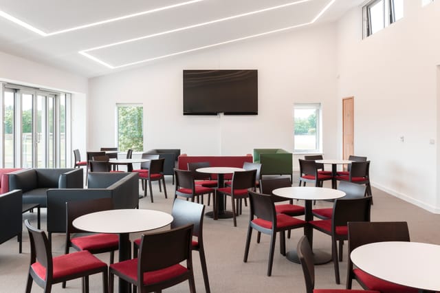 UCS New Pavilion Eve Lounge: modern meeting space with natural light for events and gatherings.