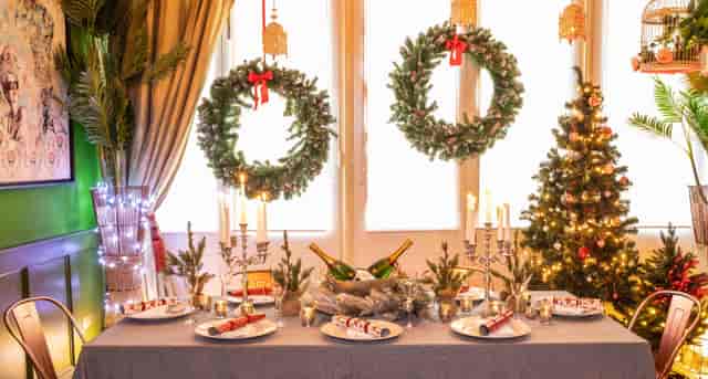 Elegant Christmas event space with festive decor and a sparkling tree at The Little Blue Door.
