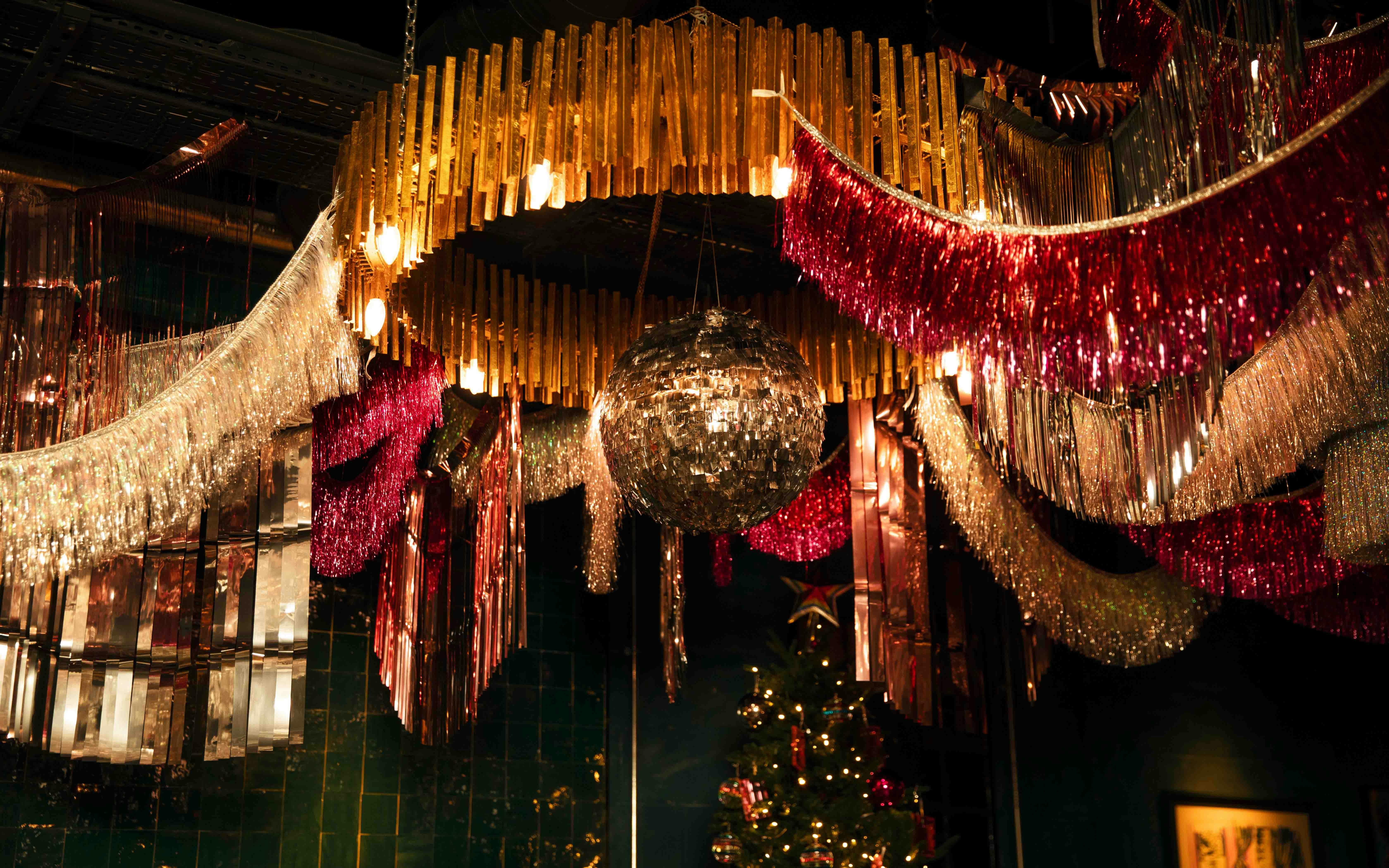 Vibrant Christmas event space with disco ball and colorful decor at The Little Scarlet Door.