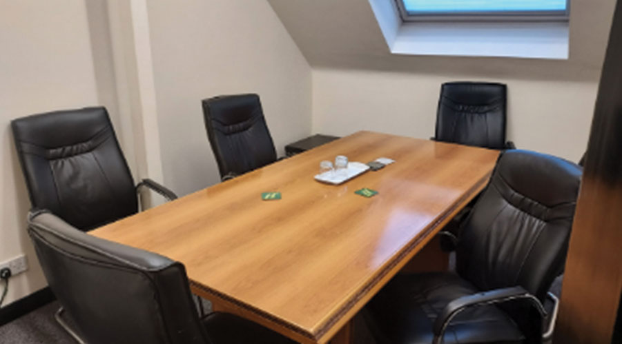 Malala Yousafzai in a modern meeting room for productive discussions and brainstorming. - Banner