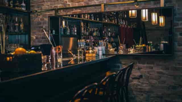 Stylish cocktail bar with warm lighting, perfect for intimate gatherings and networking events.