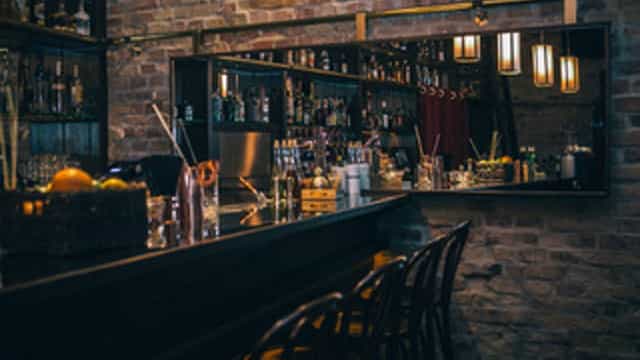 Stylish cocktail bar with warm lighting, perfect for intimate gatherings and networking events.