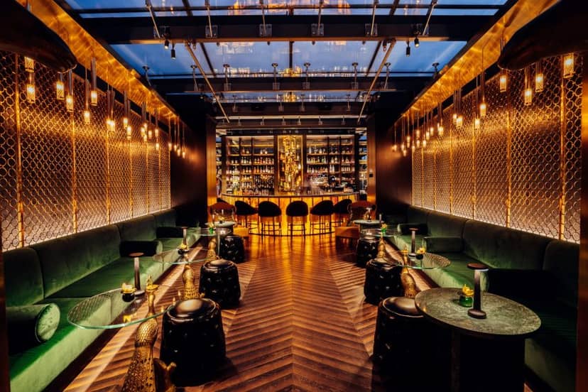 Stylish cocktail bar with warm lighting, perfect for upscale events and gatherings.