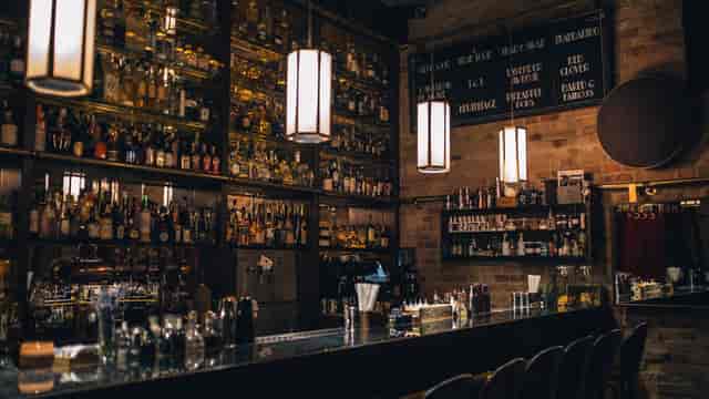 Stylish cocktail bar with warm lighting, perfect for networking events and receptions.