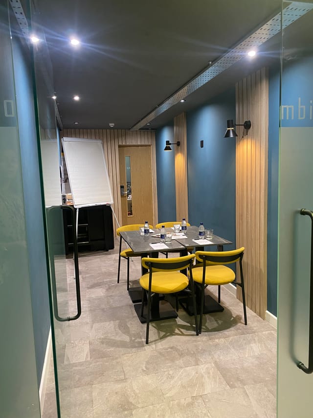Modern meeting room at The Plaza Hotel, Chorley with stylish yellow chairs for workshops.