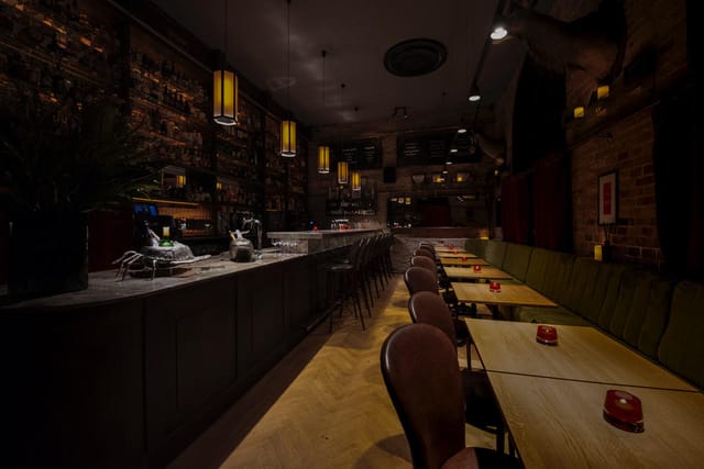 Stylish Black Swan Bar venue with sleek bar, ideal for gatherings and networking events.