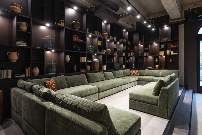 Modern lounge area in Twentysix Budapest, featuring green seating for networking events.