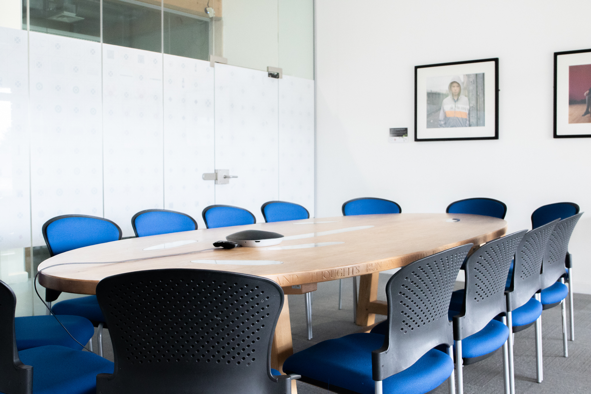 Modern conference room with oval table, ideal for meetings and brainstorming sessions.