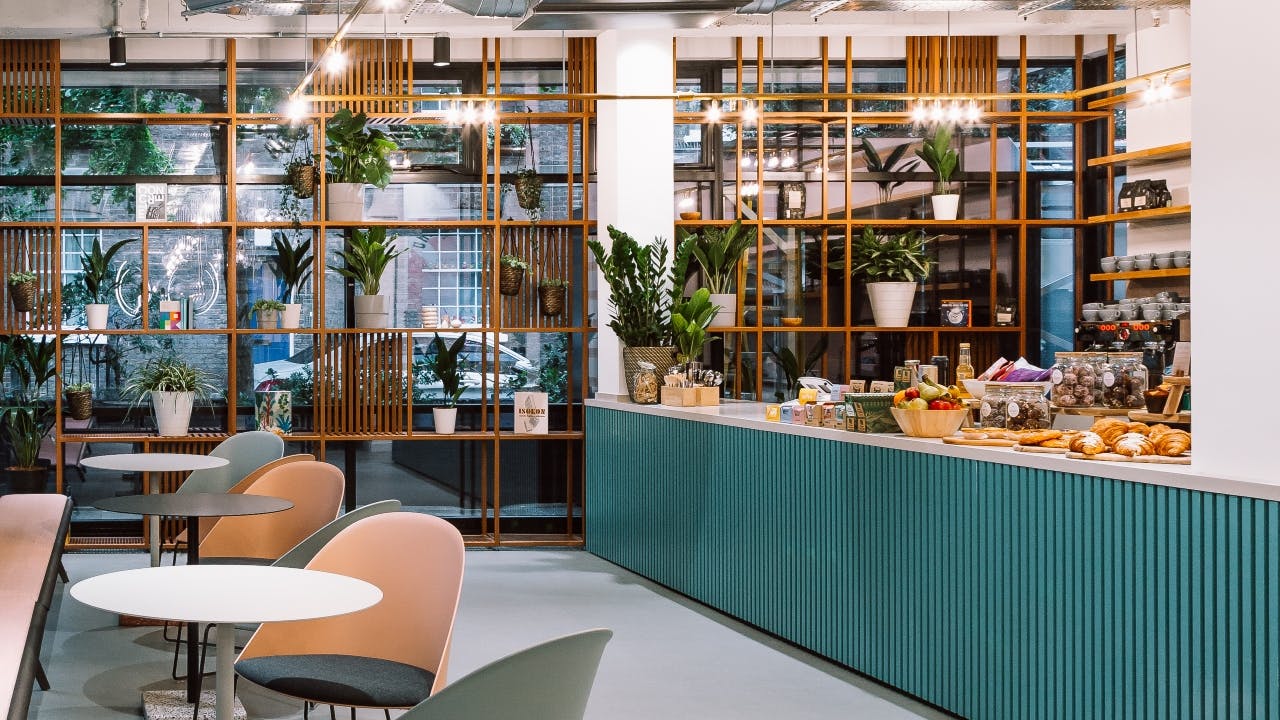 Modern event space with stylish café, ideal for networking and meetings.