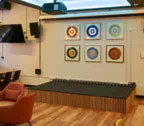 Versatile event space at Freddie's bar with stage, ideal for presentations and performances.