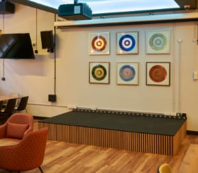 Versatile event space at Freddie's bar with stage, ideal for presentations and performances.