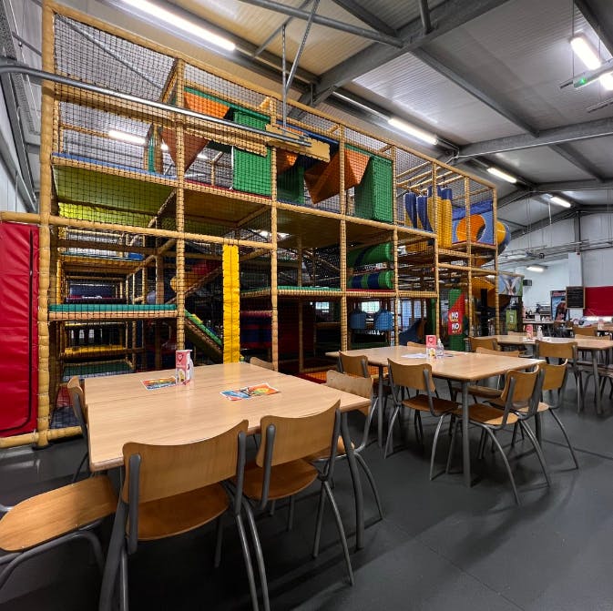 Vibrant indoor play area with climbing structure for kids' birthday parties in Sidcup.