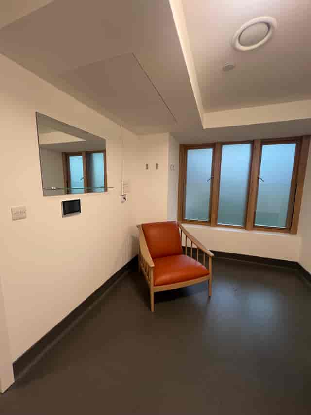 Minimalist meeting space in Bermondsey Spa with modern chair and frosted windows.