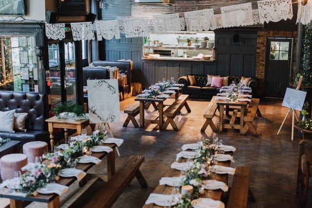 Elegant event space at The Depot N7 with floral centerpieces, ideal for weddings and gatherings.