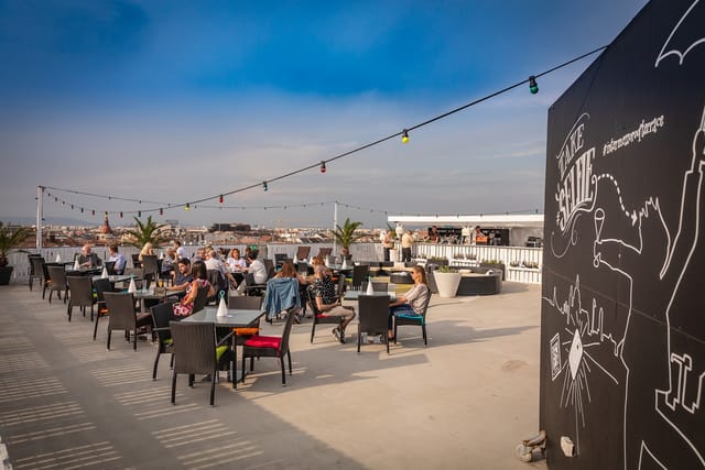 Vibrant rooftop venue with skyline view for networking events and gatherings.