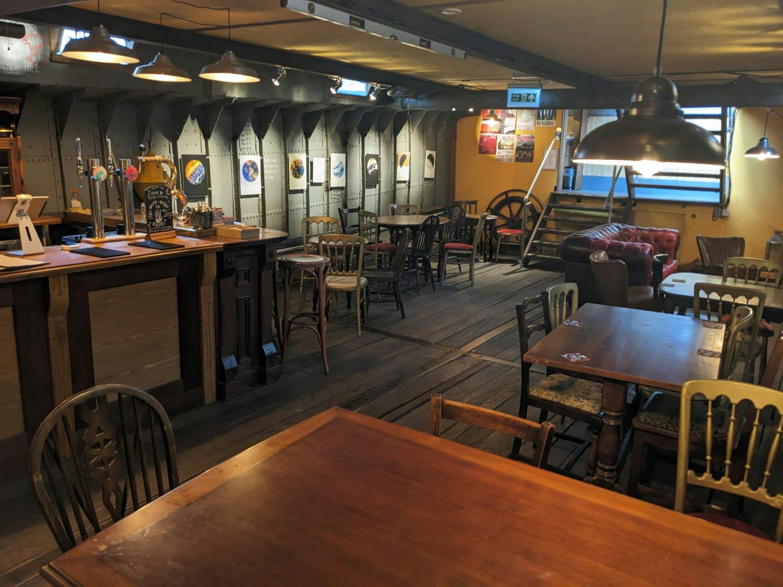 Cozy rustic event space with warm lighting for intimate gatherings and meetings.