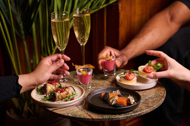 Elegant table with gourmet appetizers at The American Bar, perfect for networking events.