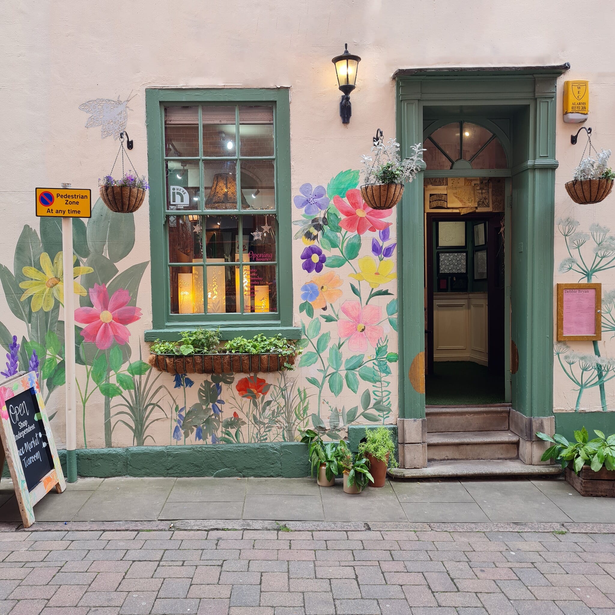 Charming Tea Rooms entrance with vibrant floral murals for events and workshops. - Banner