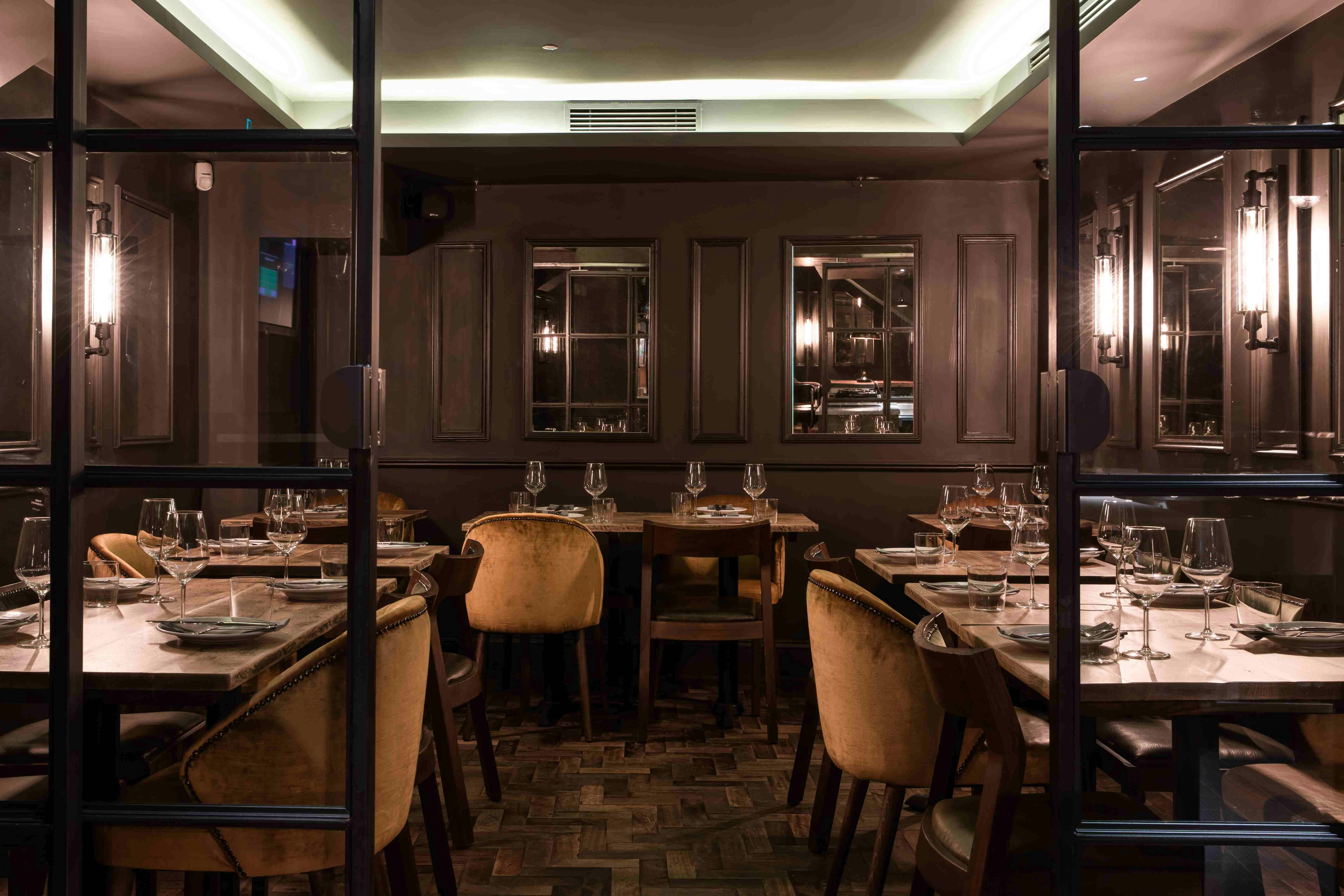 Elegant Ember Bar dining space with warm lighting for intimate gatherings and corporate events.