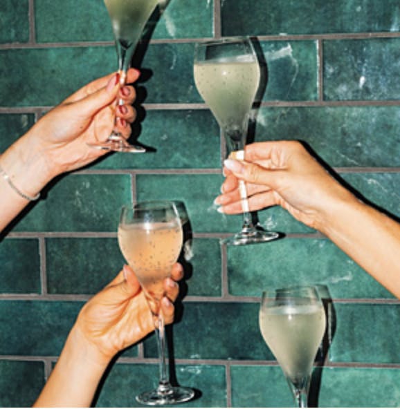 Celebratory toast at The Botanist Liverpool One, elegant glassware for events.