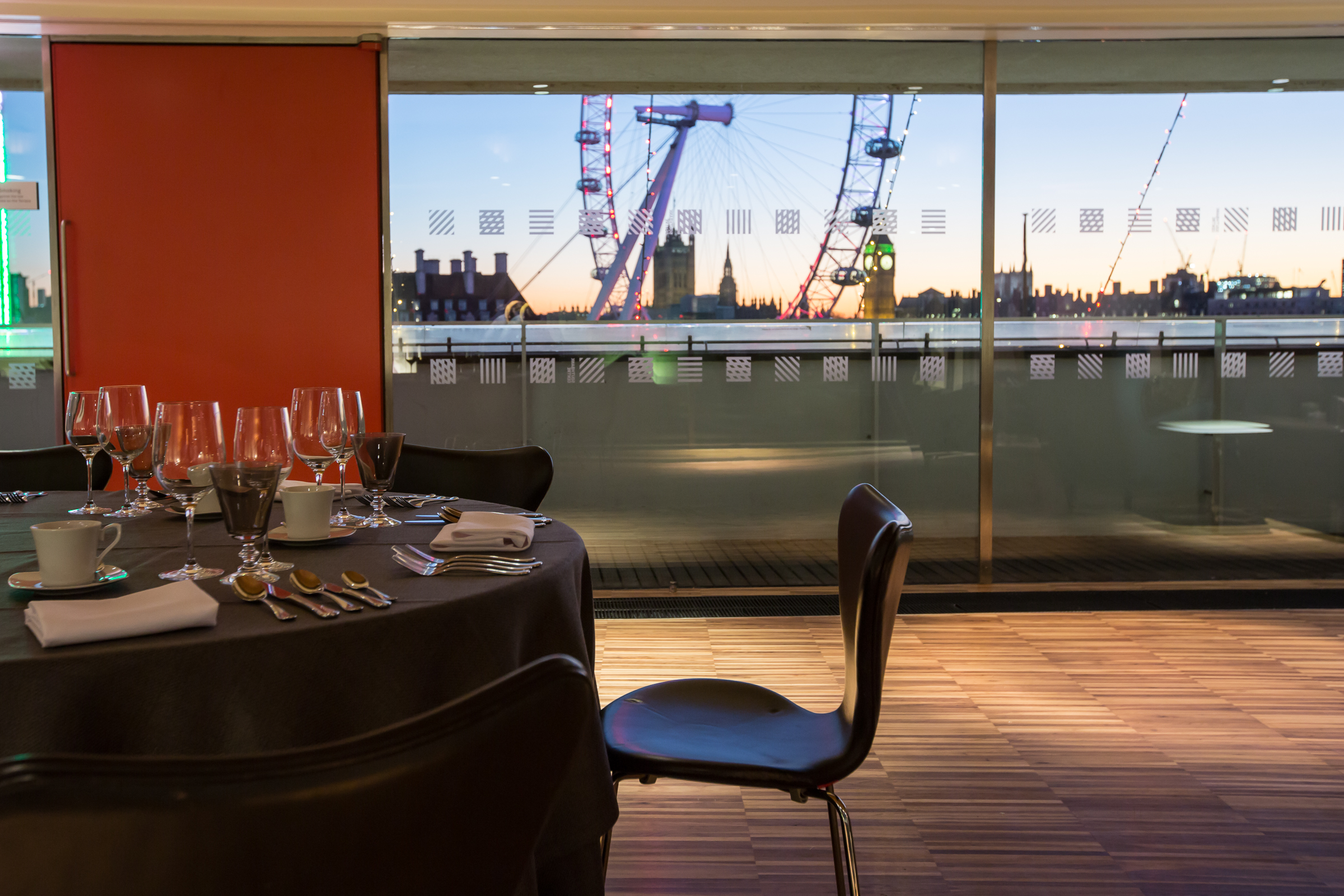 Festive Southbank Centre event with elegant dining and London Eye sunset view. - Banner