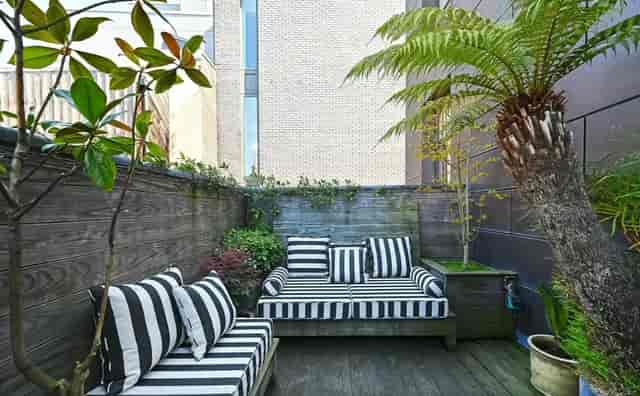 Roof Terrace in 1900s Brewery with striped seating, ideal for outdoor gatherings and meetups.
