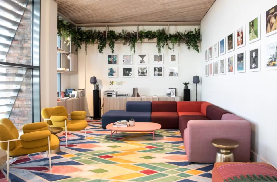 Vibrant lounge area with colorful furniture for networking events and informal meetings. - Banner