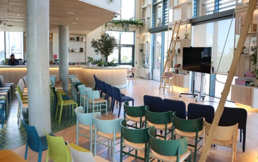 Top floor event space with colorful chairs, ideal for meetings and workshops.