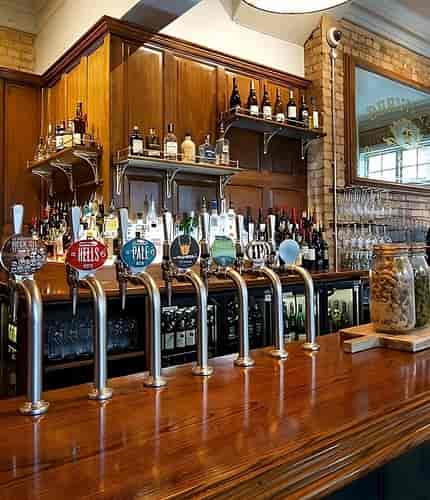 Bar area at The Vine with polished wood counter, ideal for networking events and social gatherings.