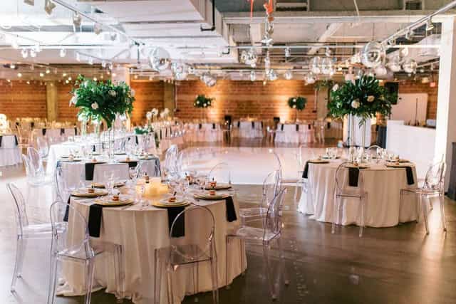 Elegant event space with round tables, floral decor for weddings and corporate events.