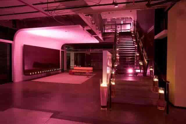 Stylish lounge with illuminated staircase, perfect for upscale fashion events.