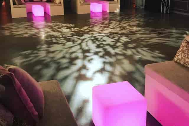 Stylish lounge with illuminated furniture for networking events in fashion industry.