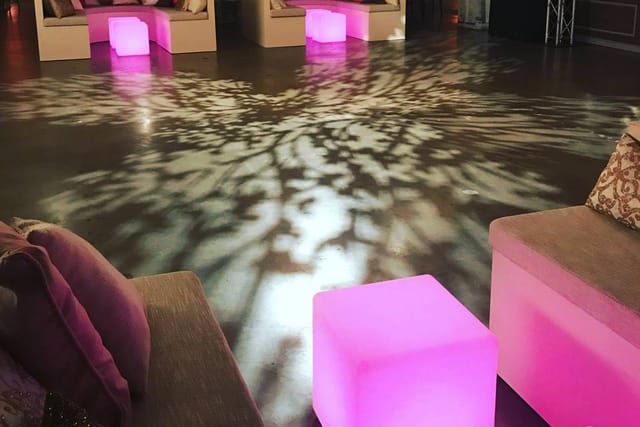 Stylish lounge with illuminated furniture for networking events in fashion industry.